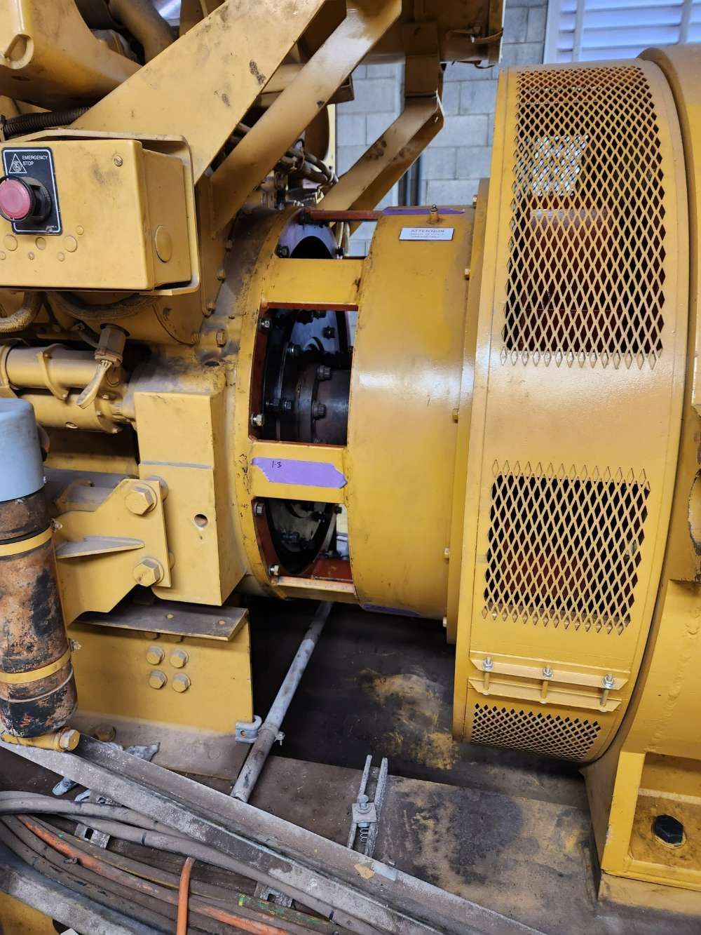 A Large Yellow Machine Is Sitting On A Wooden Floor — Great Energy in Port Douglas, QLD