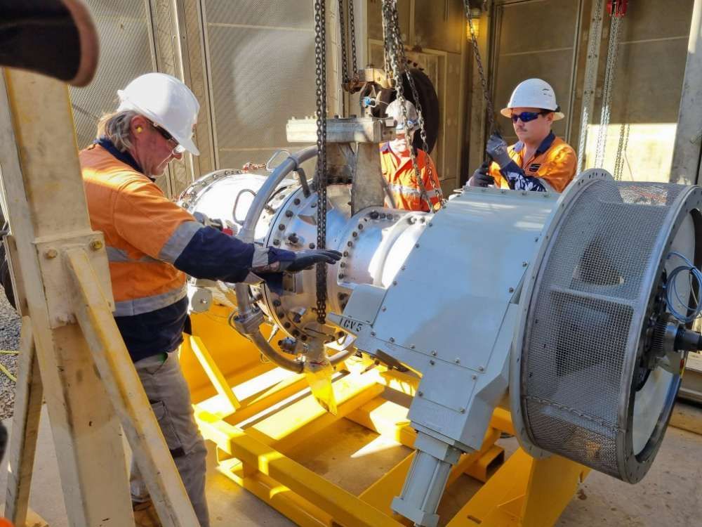 A Group Of Men Are Working On A Large Machine — Great Energy in Port Douglas, QLD
