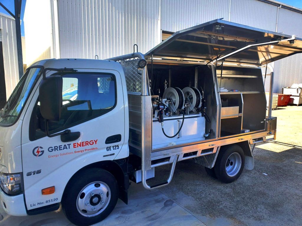 A White Truck With A Canopy Open Is Parked In Front Of A Building — Great Energy in Portsmith, QLD