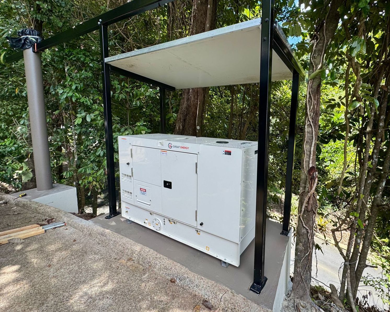 A Generator Is Sitting On A Sidewalk In Front Of A House — Great Energy in Portsmith, QLD