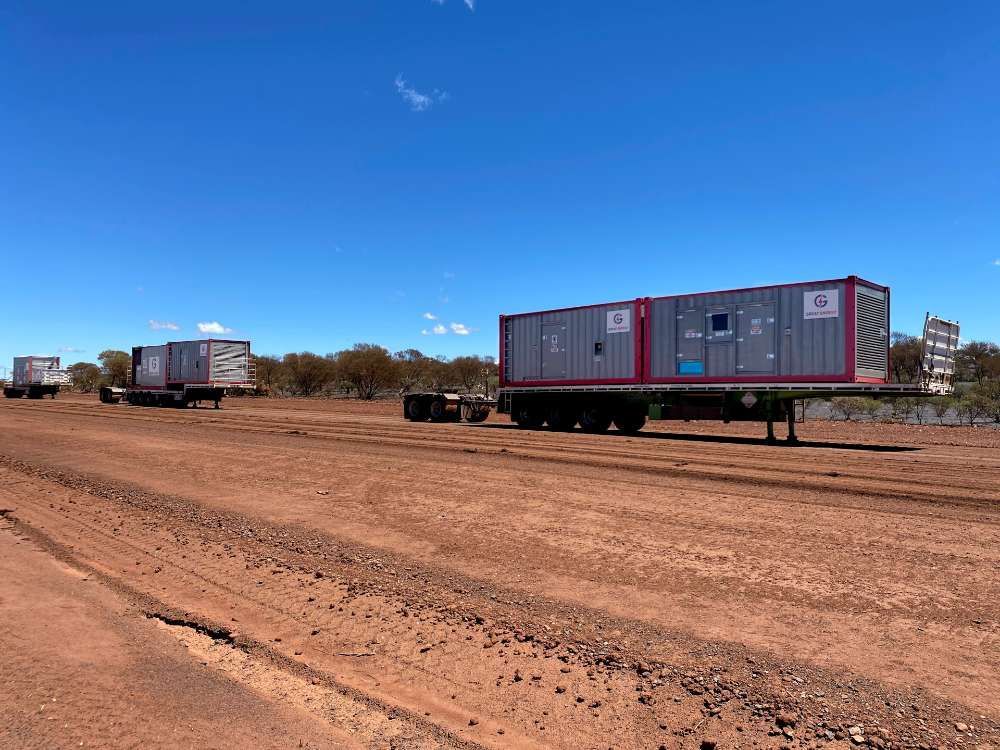 A Row Of Trailers Are Parked In A Dirt Field — Great Energy in Portsmith, QLD