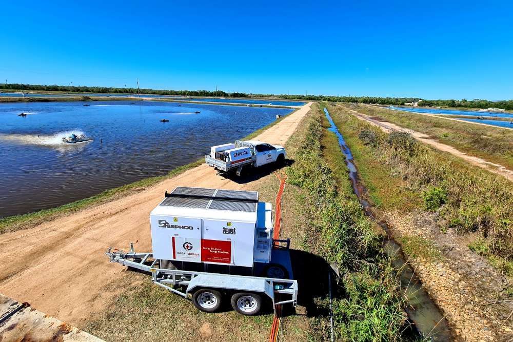 A Truck Is Driving Down A Dirt Road Next To A Body Of Water — Great Energy in Portsmith, QLD