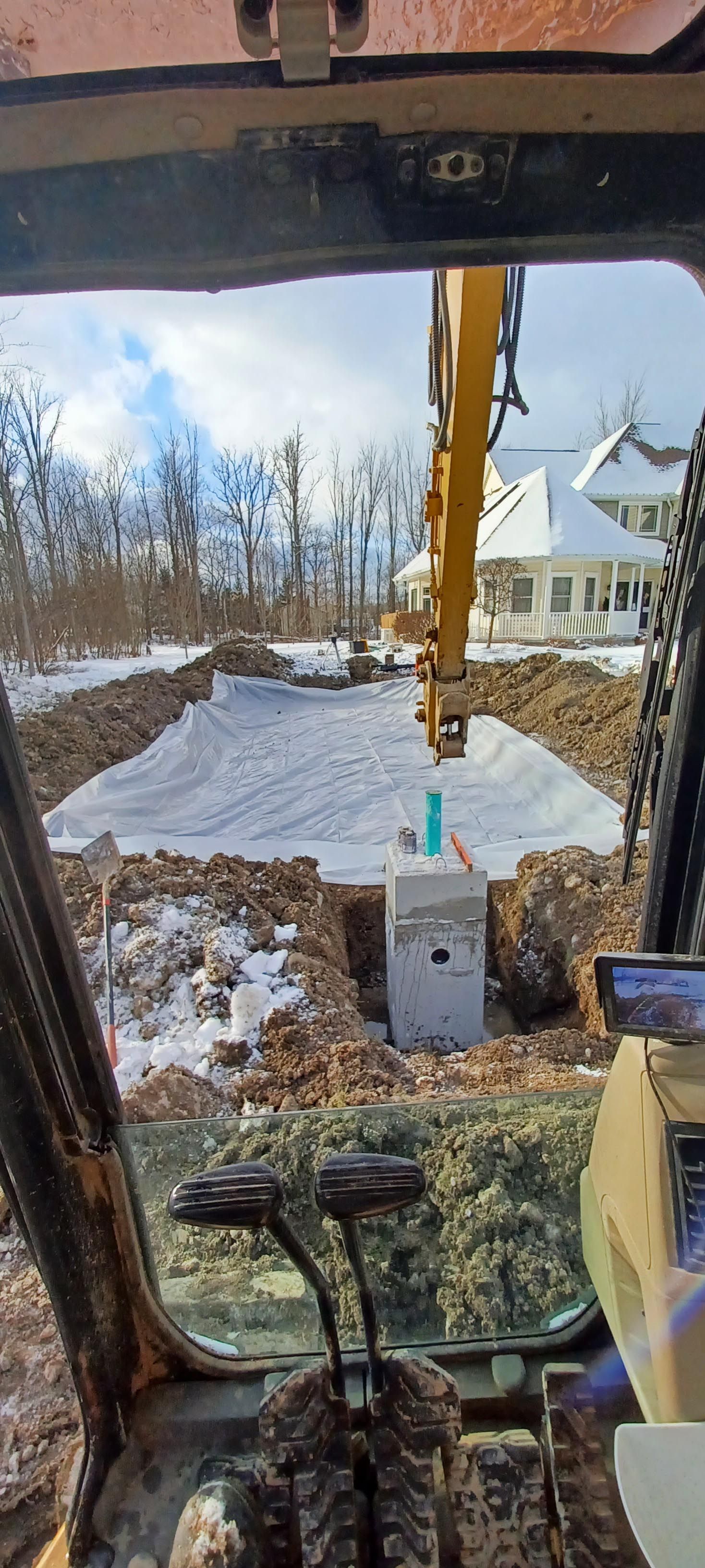 A person is driving a bulldozer on a dirt road.