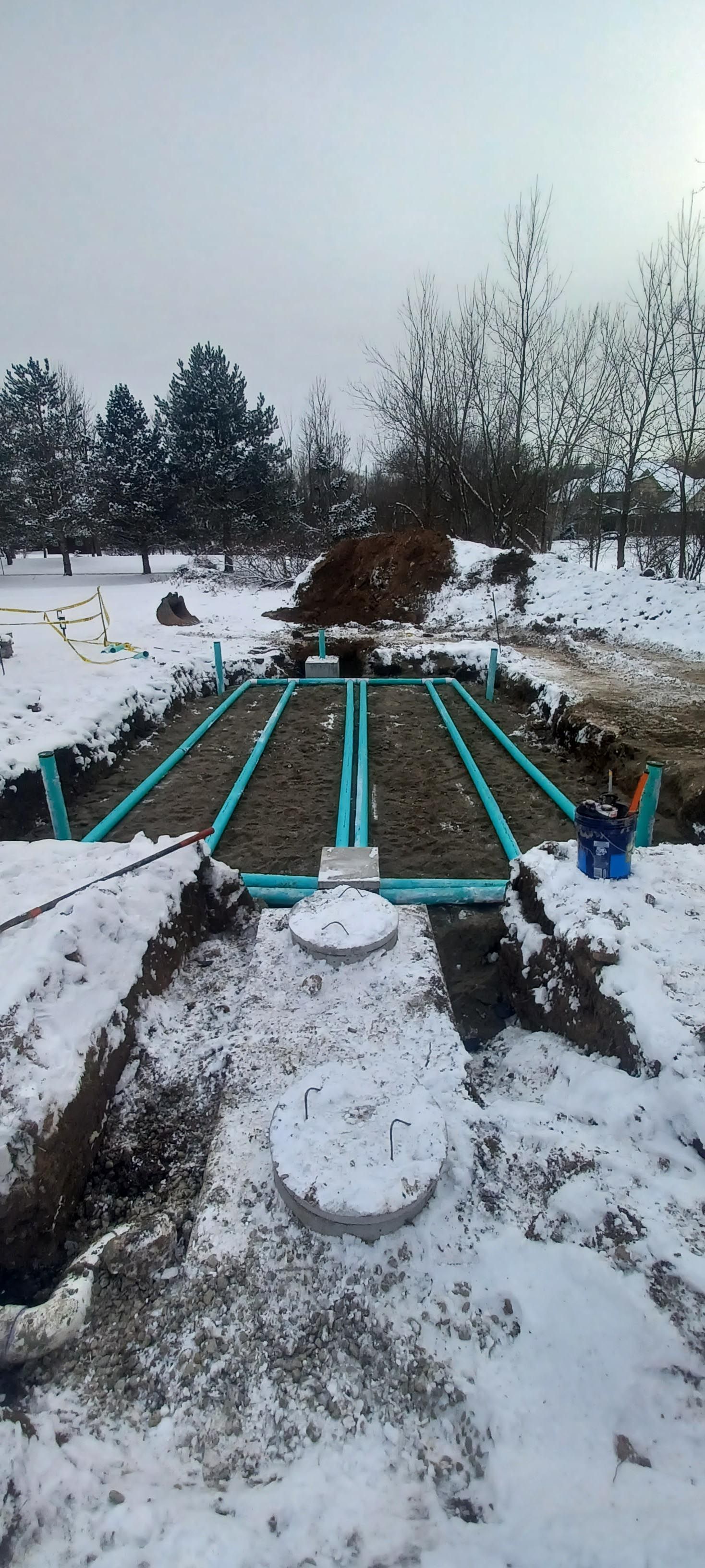 A septic system is being installed in the snow.
