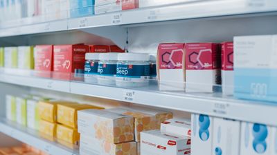 A pharmacy shelf filled with lots of different types of medications.