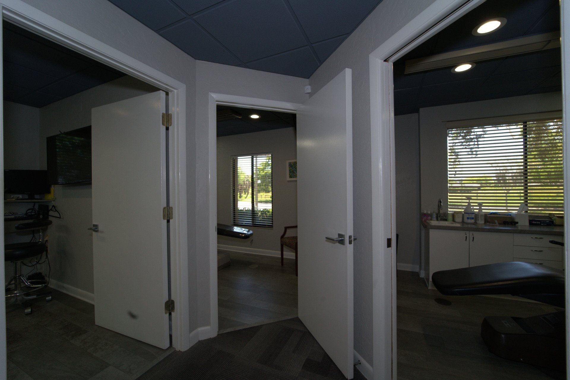 A dental office with a dental chair in the middle of the room