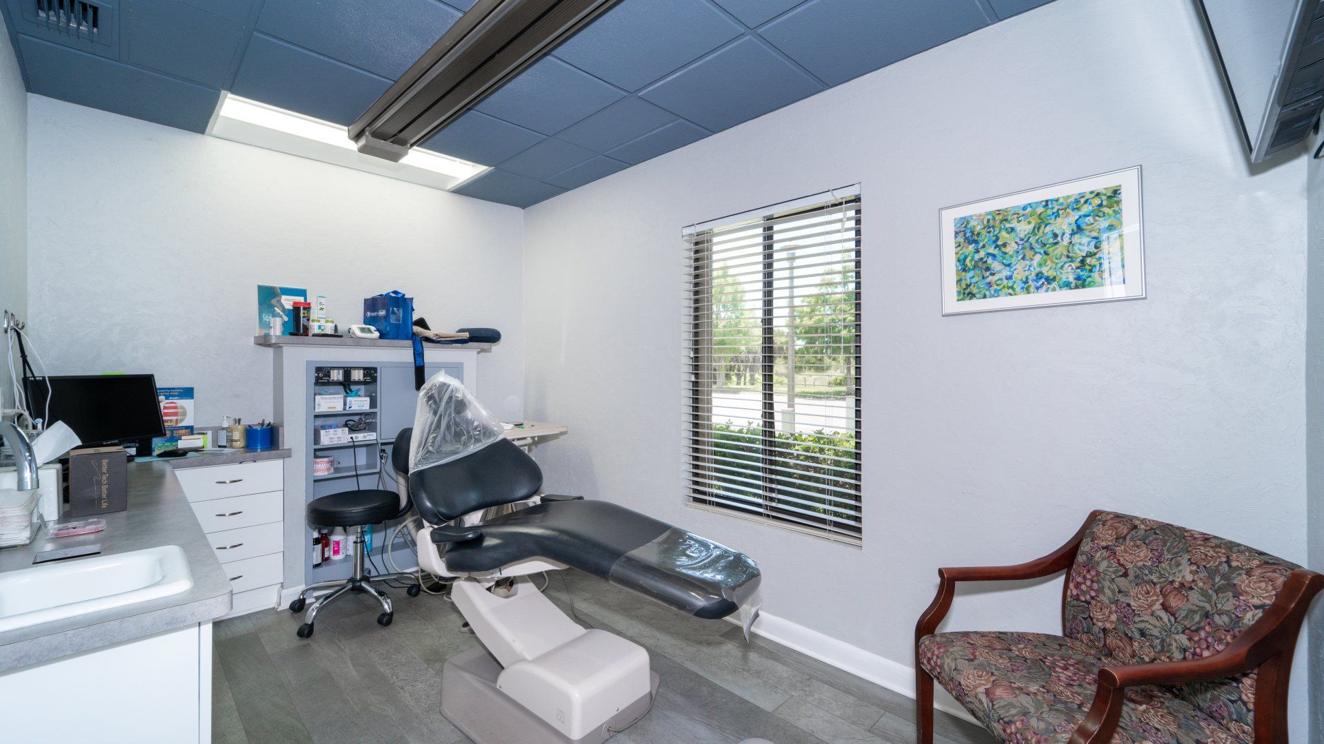 A dental office with a dental chair and a chair.