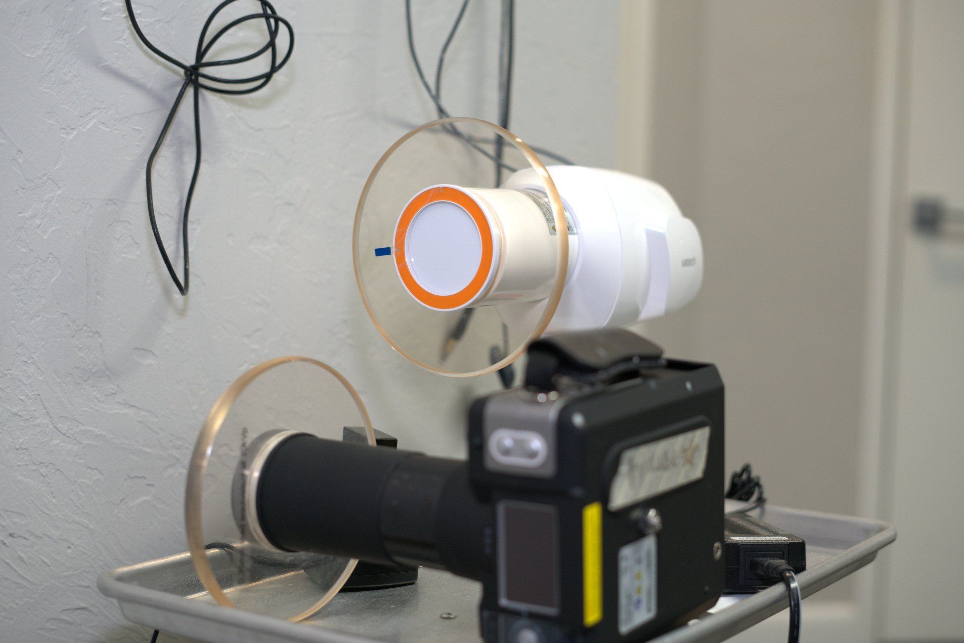 A dental x-ray machine is sitting on a tray in a dental office.