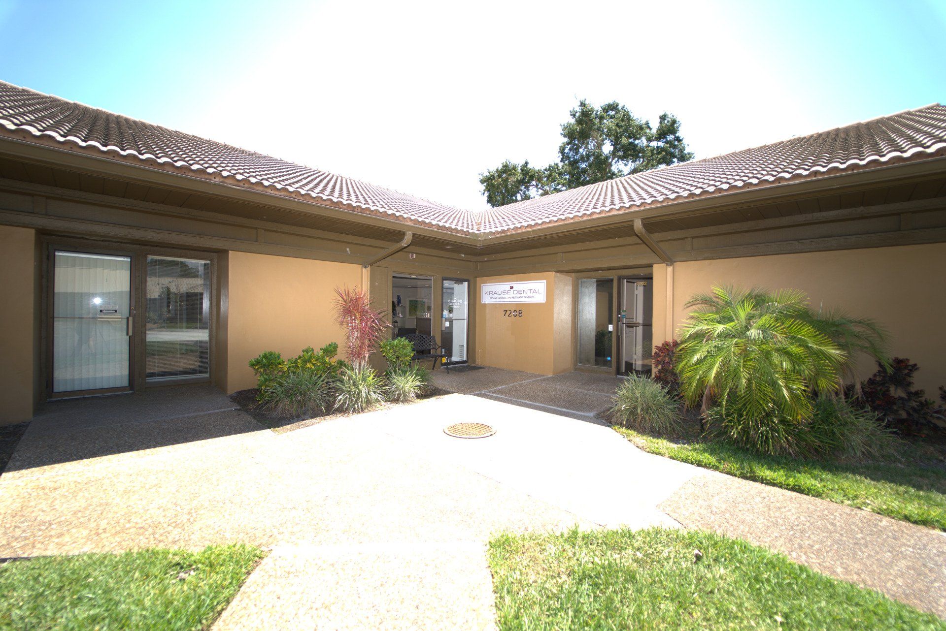 A large building with a lot of windows and a walkway leading to it.
