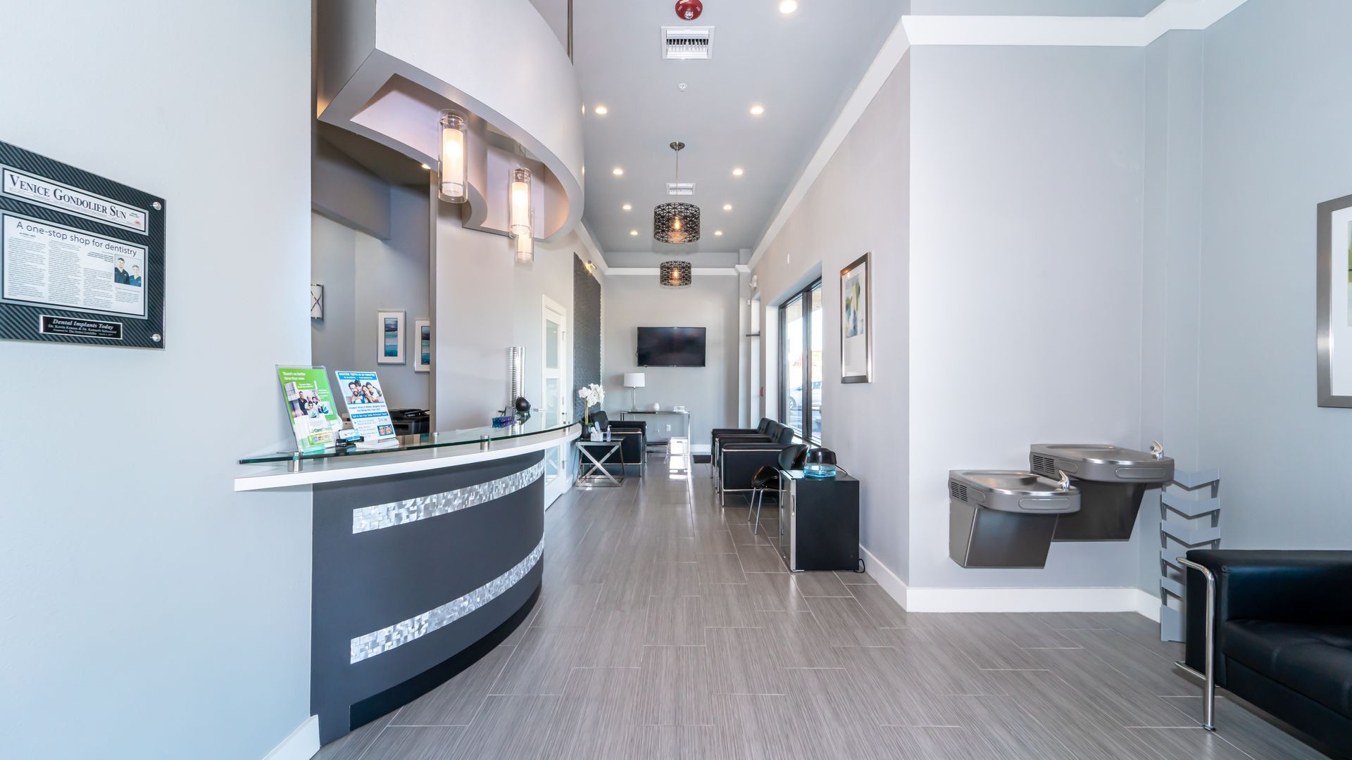 A dental office with a waiting room and a reception desk.