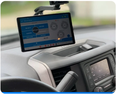 A tablet is mounted on the dashboard of a car