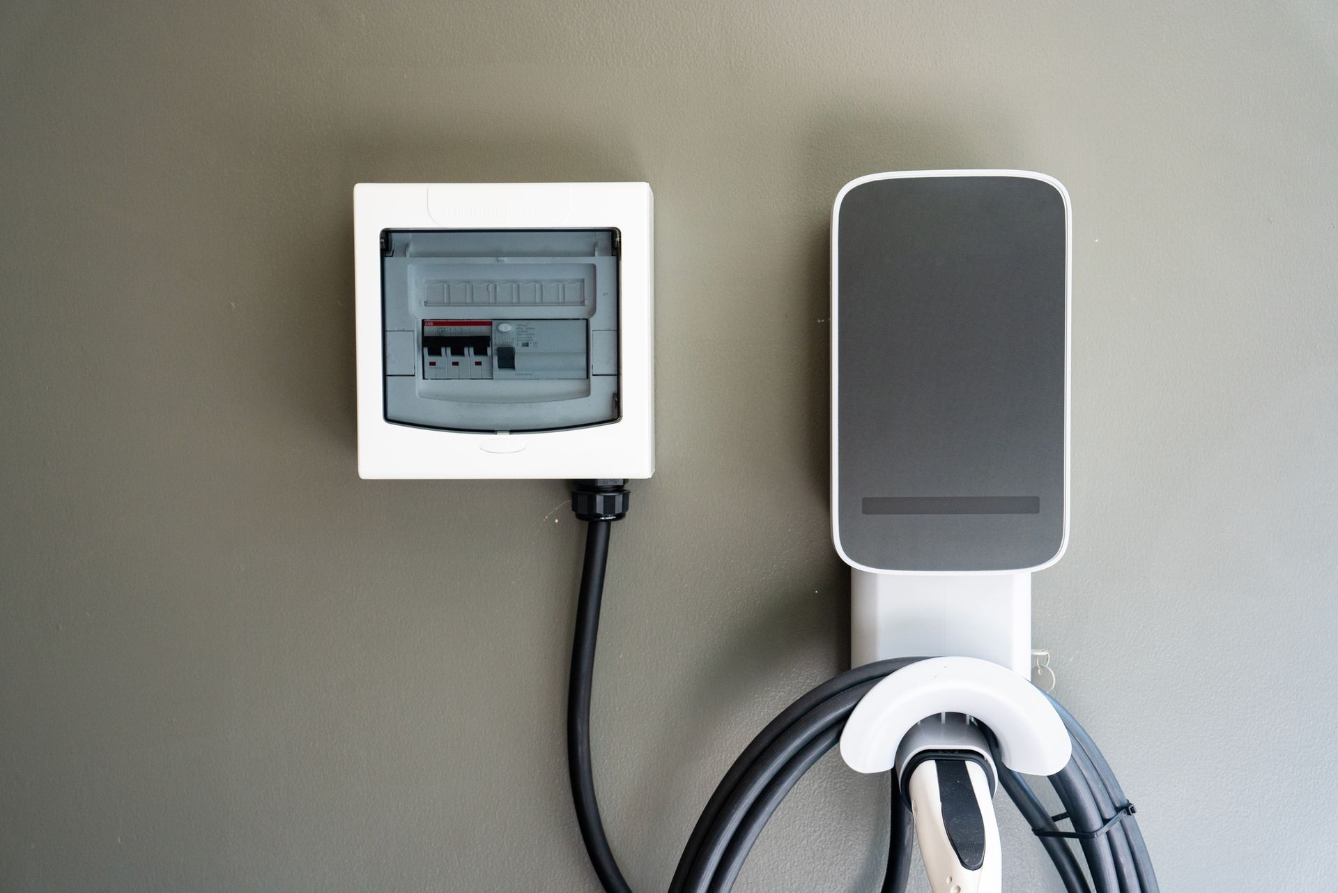 A charging station for an electric car is attached to a wall.