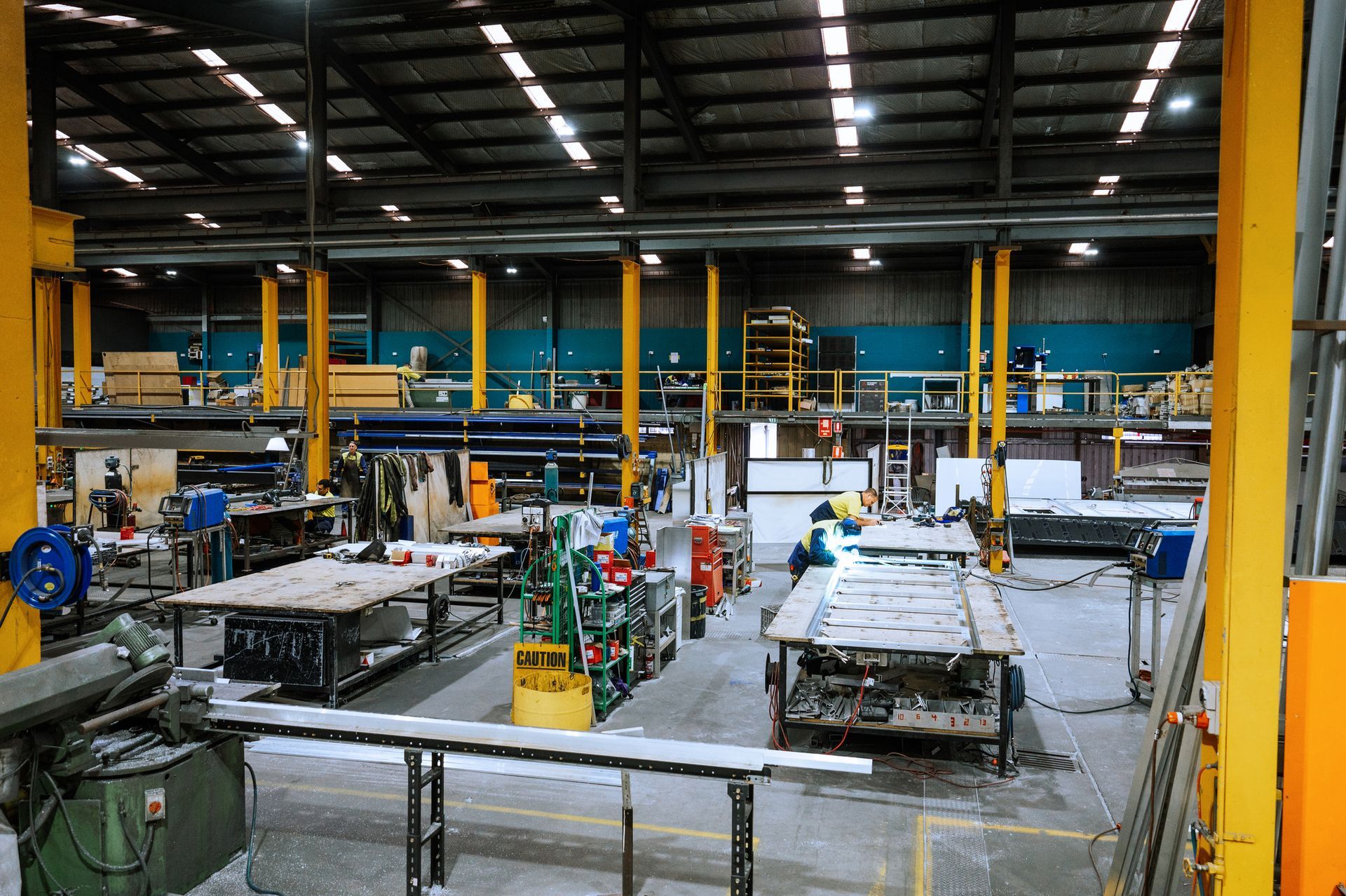 A large warehouse with lots of tables and machinery