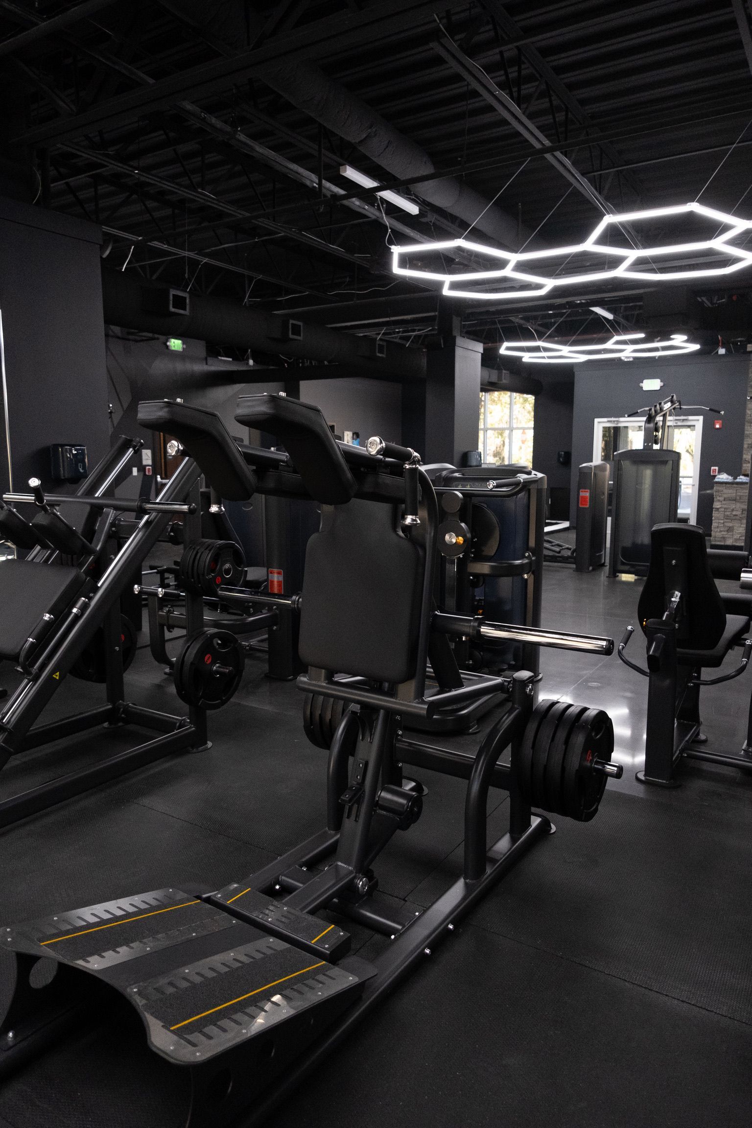 A woman is running on a treadmill in a gym.