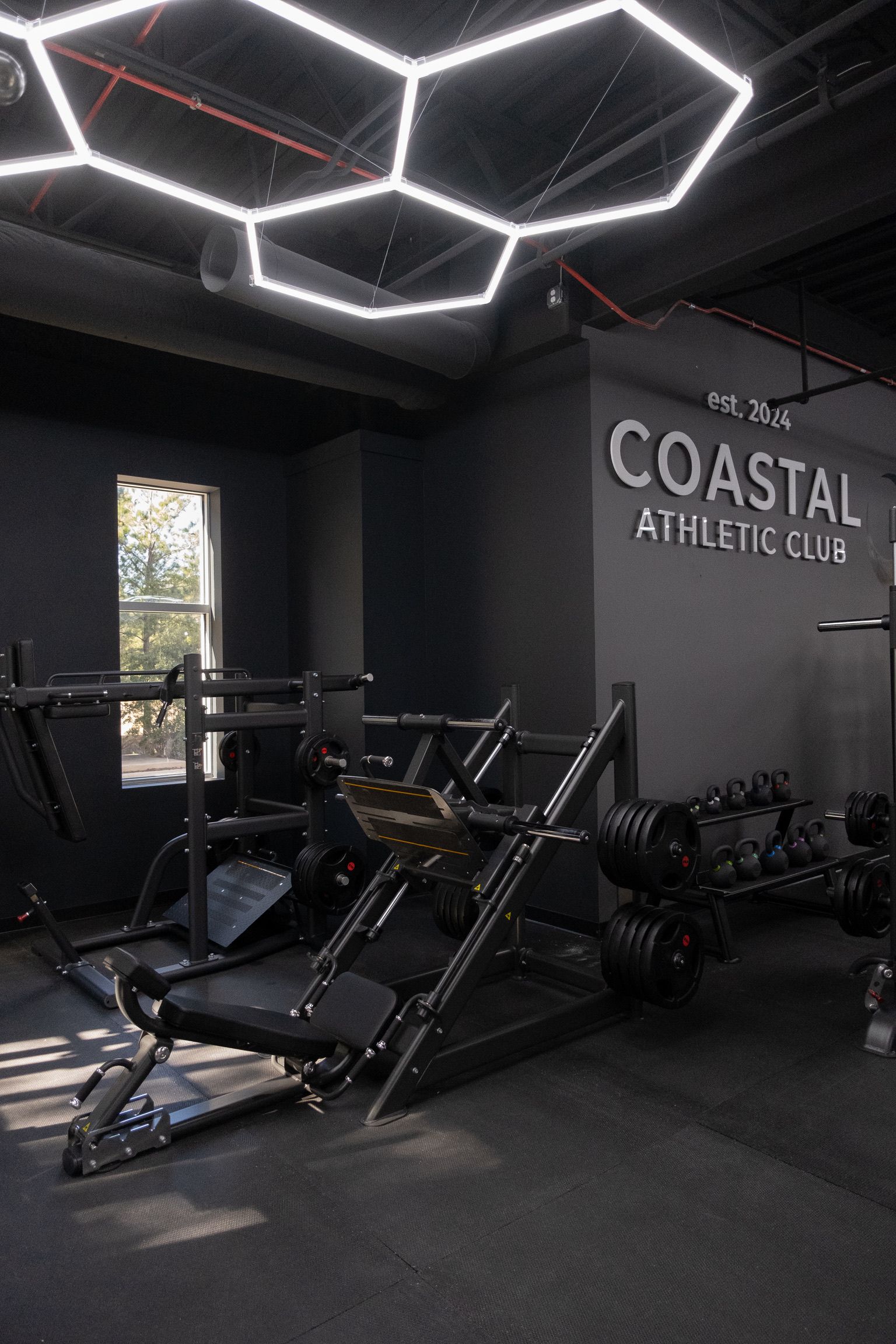 A man and a woman are giving each other a high five in a gym.