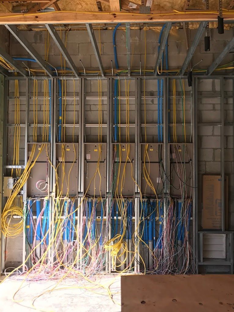 A room with a lot of wires hanging from the ceiling