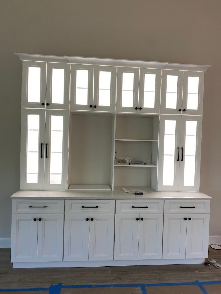 A large white cabinet with lots of drawers and shelves