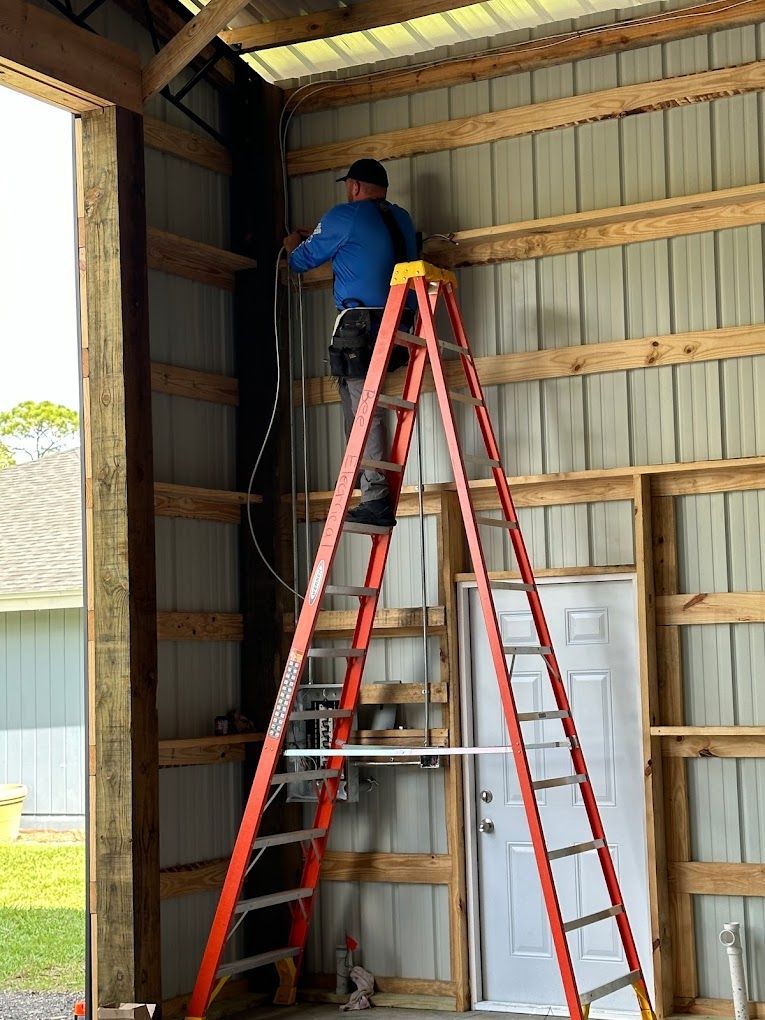 A man is standing on a ladder in a building