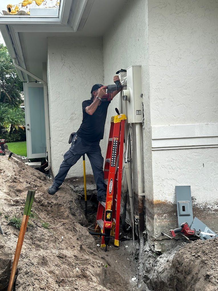 A man is standing on a ladder in front of a house.