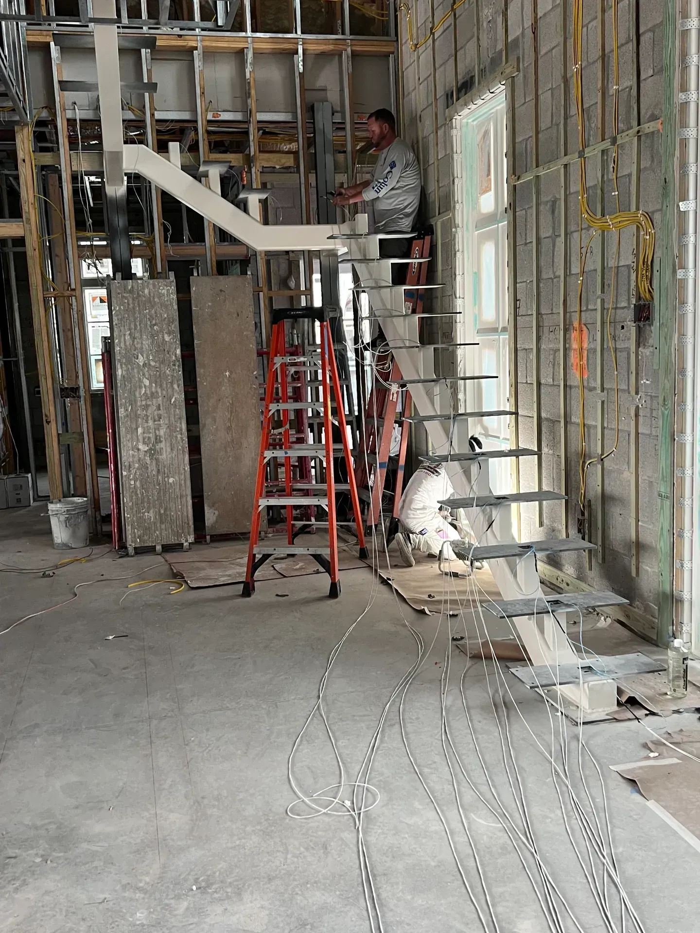 A man is working on a set of stairs in a building