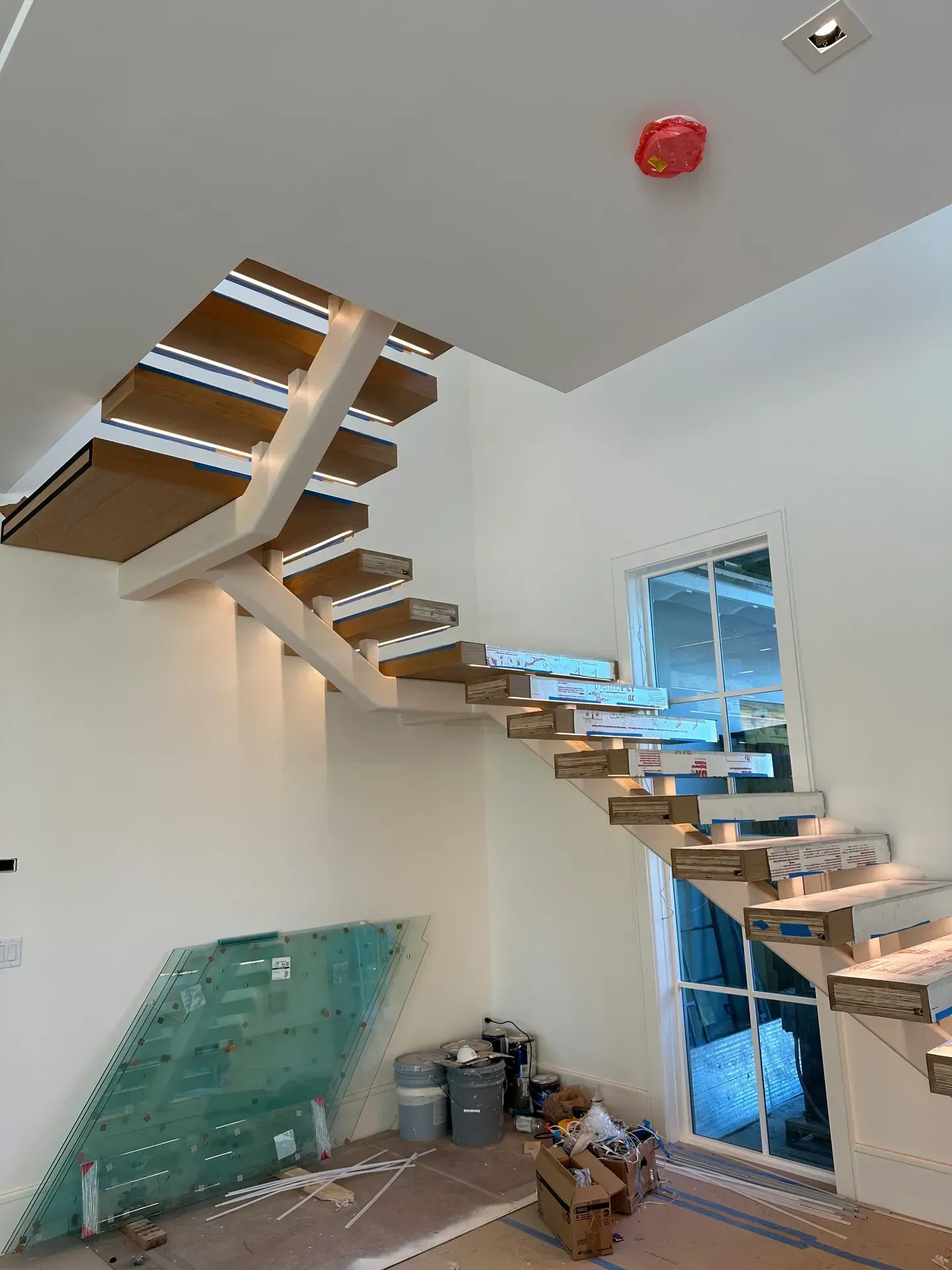 A staircase is being built in a room in a house.