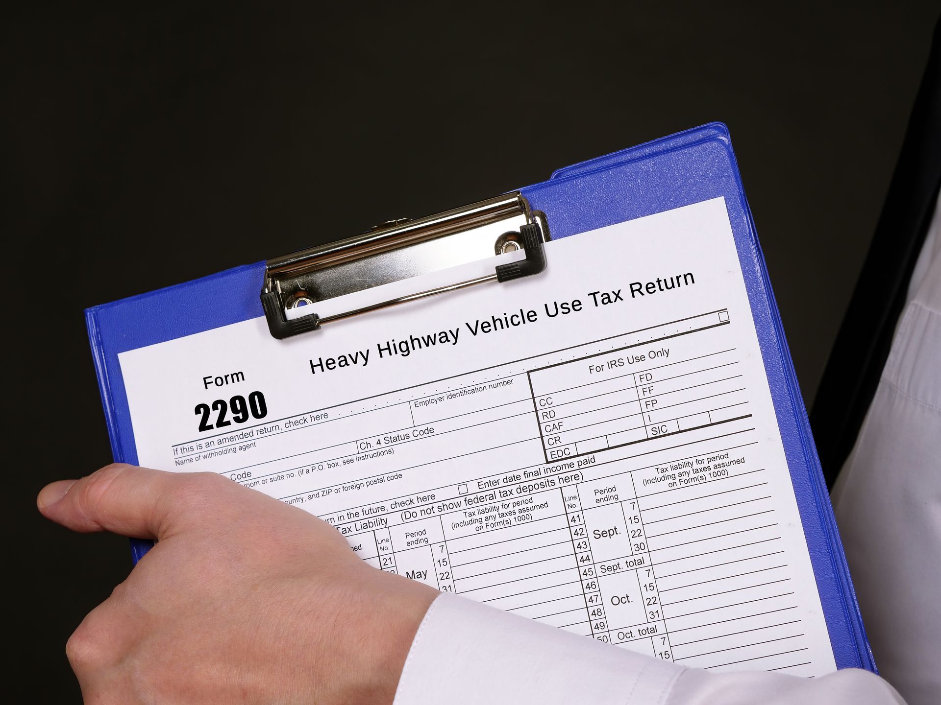 A person is pointing at a clipboard with the number 2280 on it