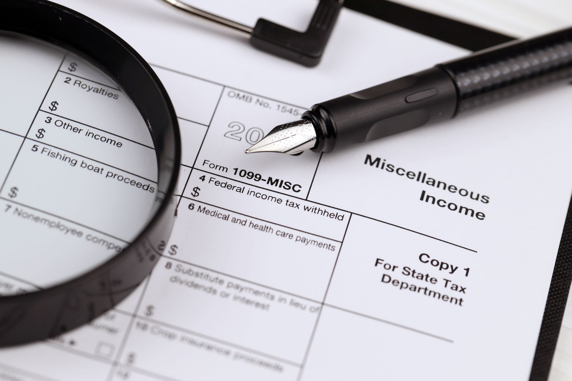 A pen is sitting on top of a miscellaneous income tax form