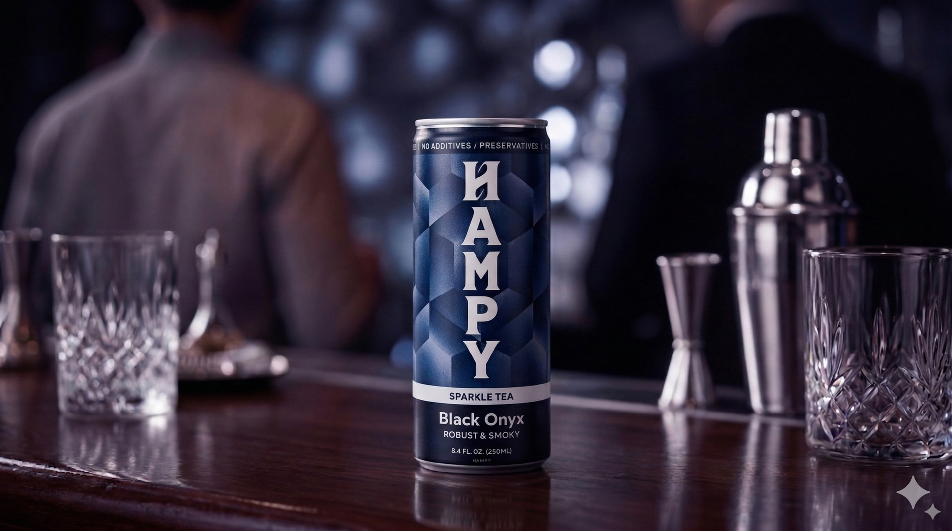 A can of HAMPY Black Onyx sparkling tea stands centered on a dark surface against a shadowed, minimalist background.