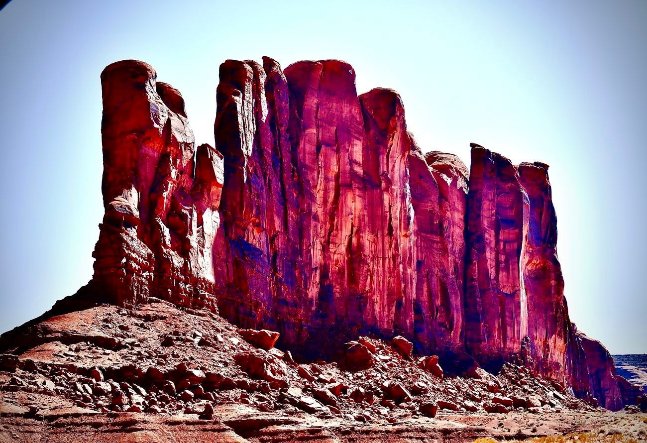 Red rock formation against a blue sky, characteristic of Monument Valley.