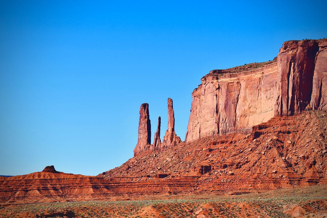 Red rock formations under a bright blue sky.