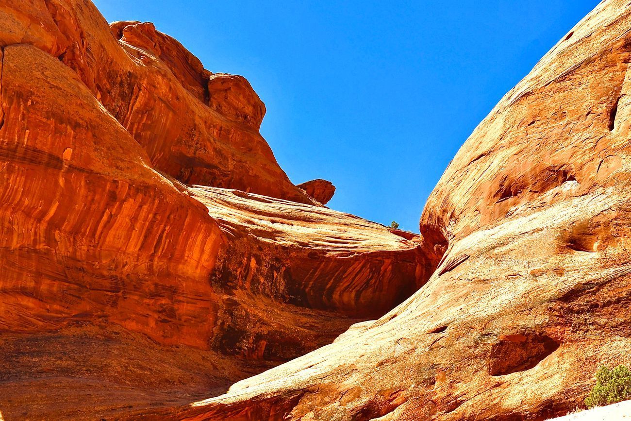 Red rock canyon walls, blue sky.