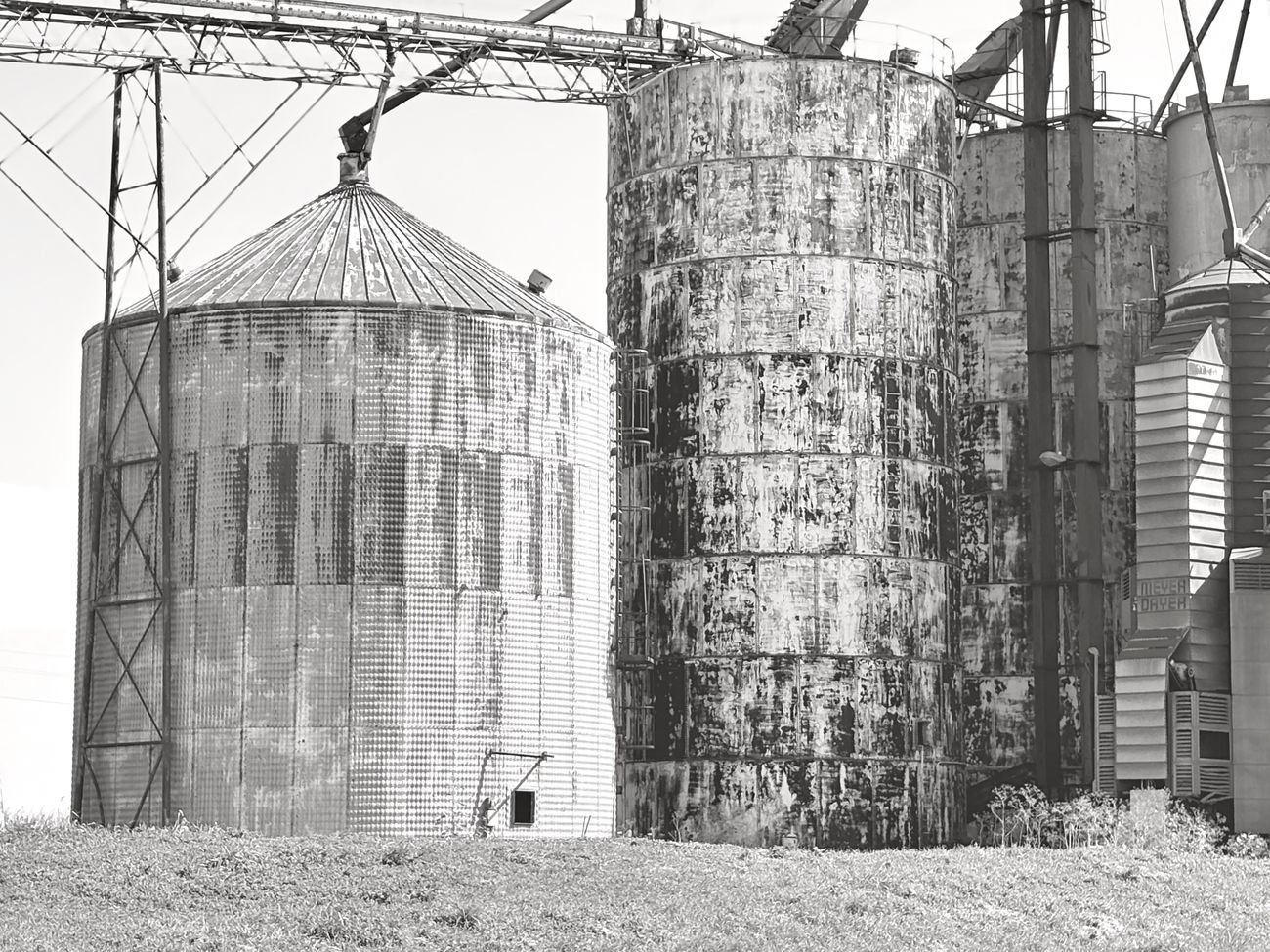 Grain silos with rusted exteriors.