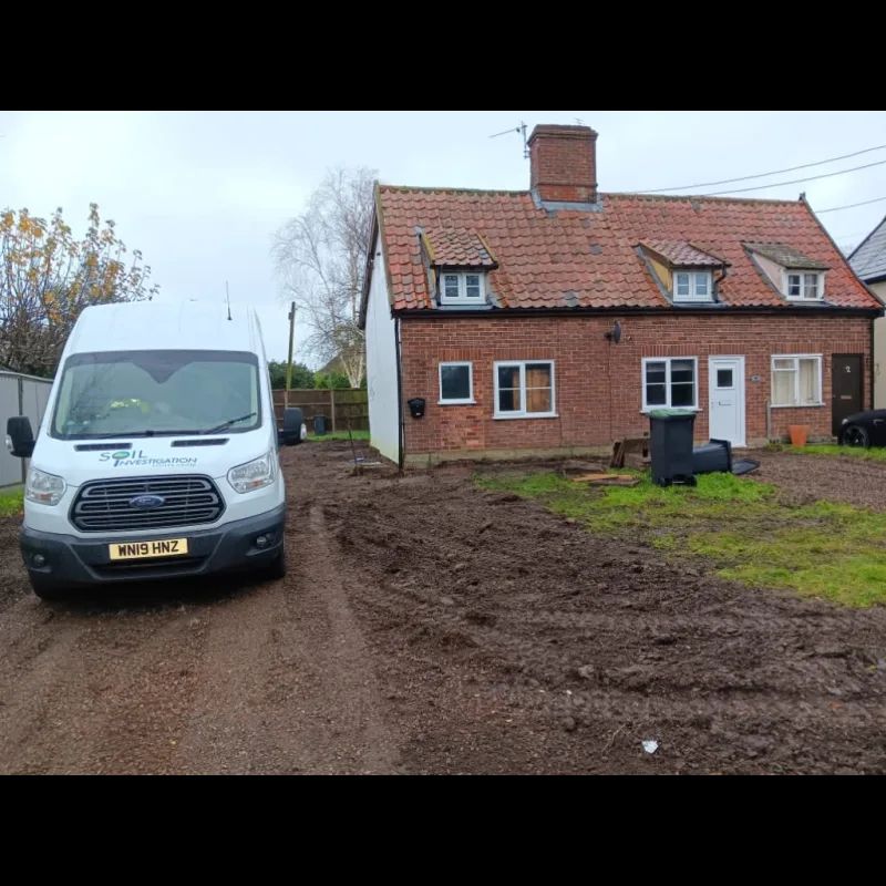 van parked on a muddy drive