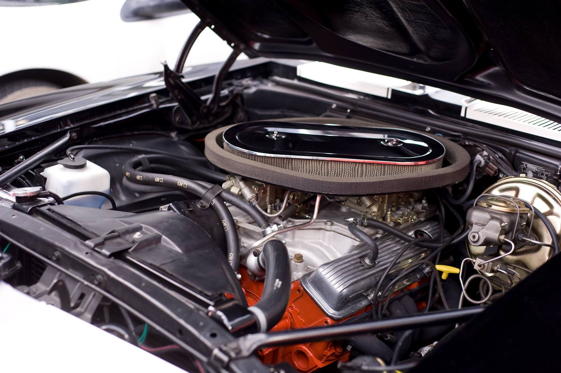 A close up of a car engine with the hood open