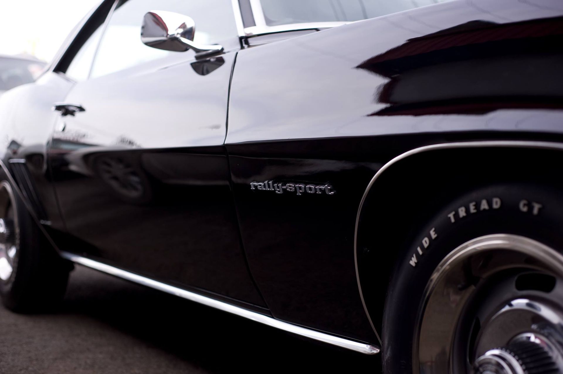 A black car with rally sport written on the side
