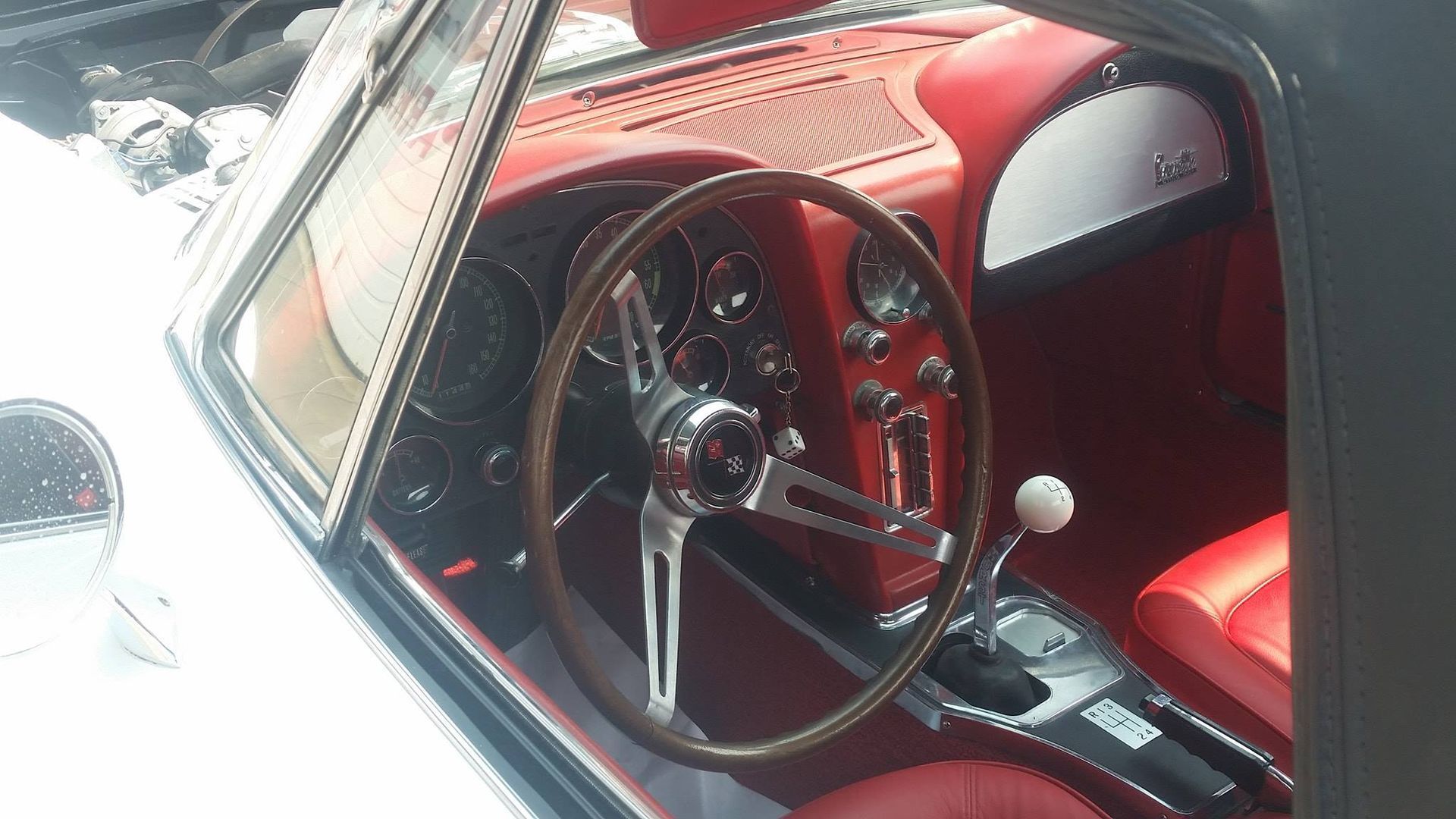 The inside of a car with red seats and a steering wheel