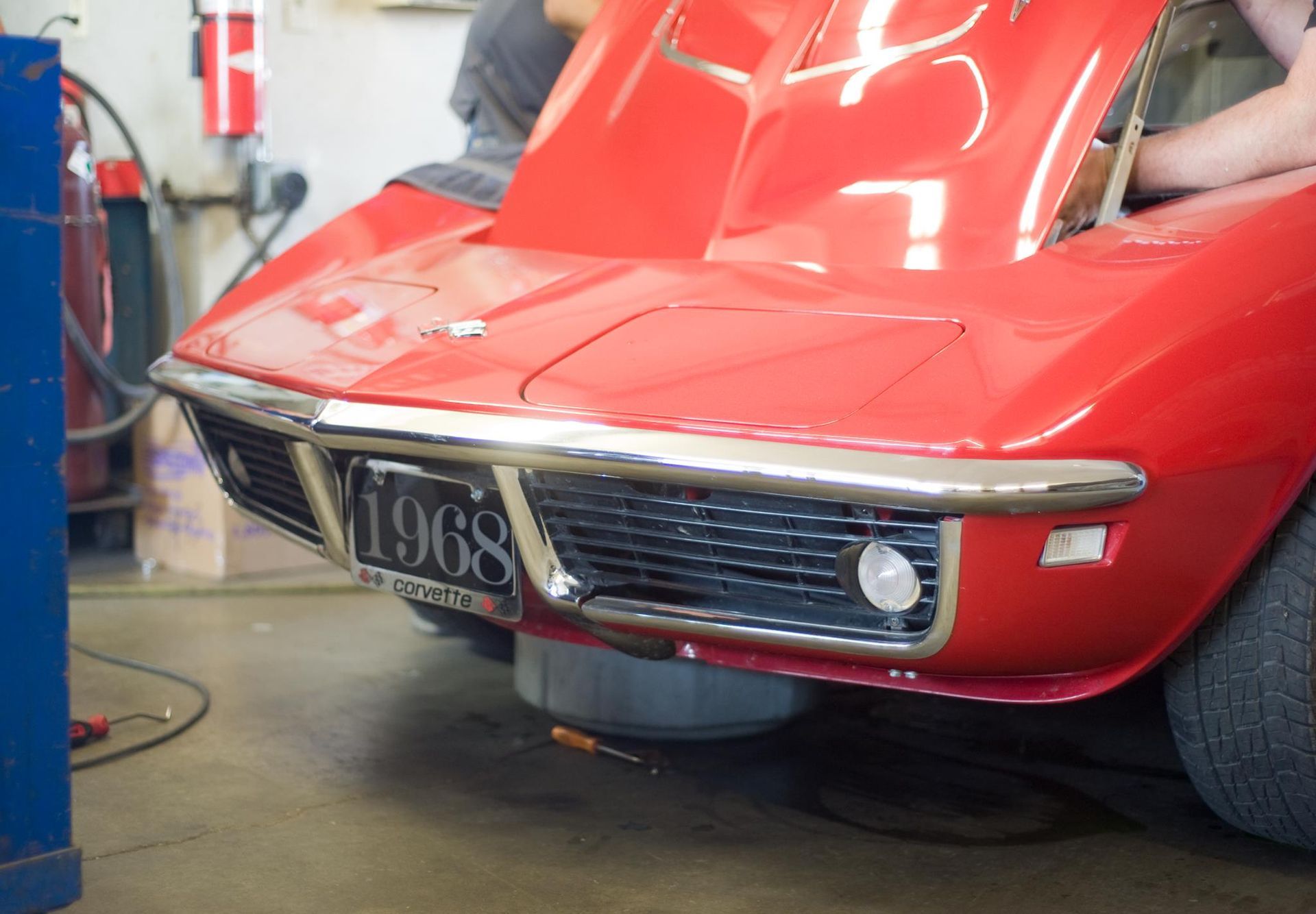 A red car with a license plate that says 1968