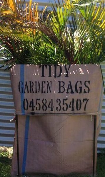 Green Trash Bin Filled With Yard Waste, Leaves, and Small Plants — Bad Bugs Pest Control in Rockhampton, QLD