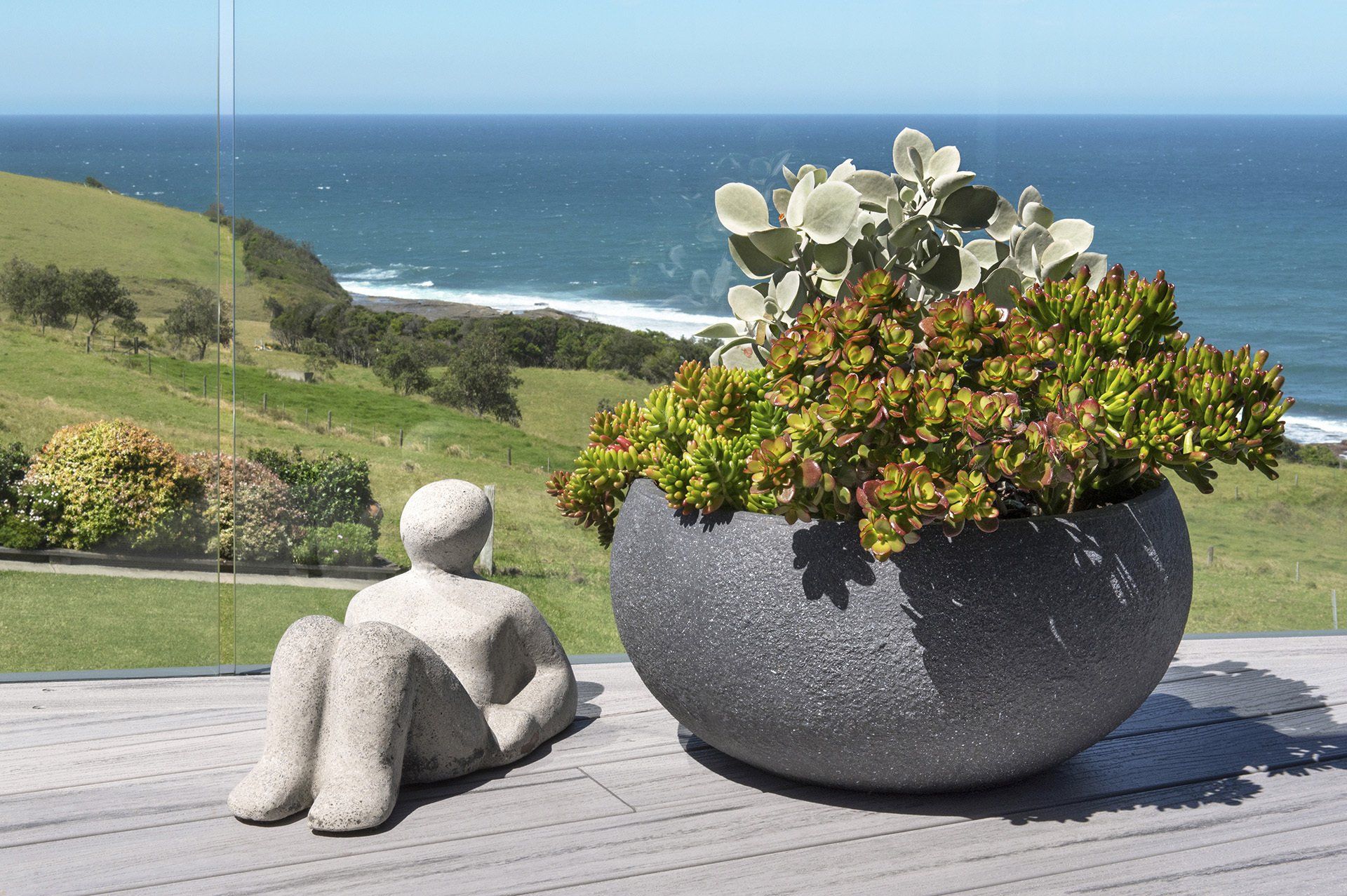 a sculpture with scenic water views in the background