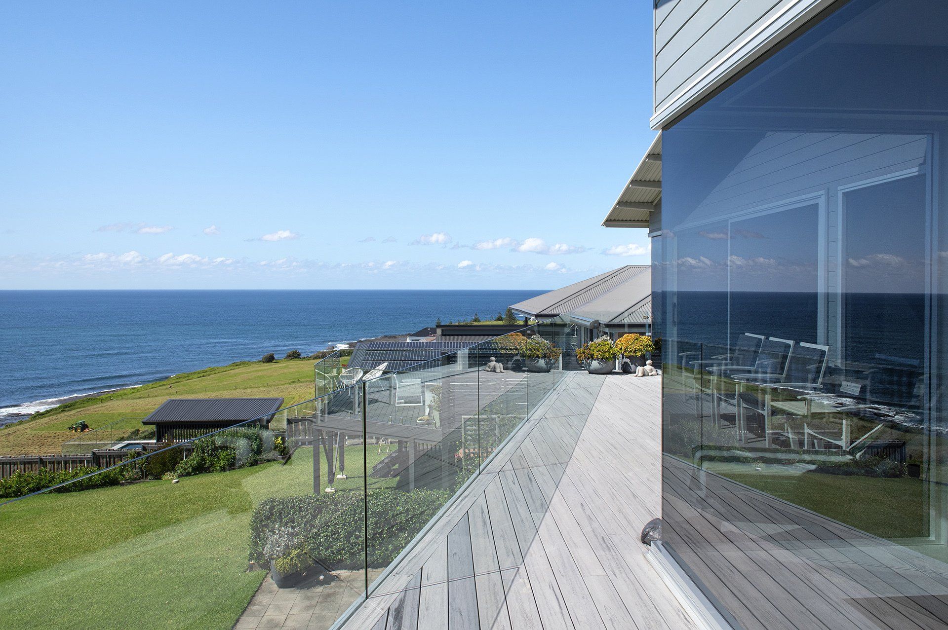rear deck with views of the ocean and farmland