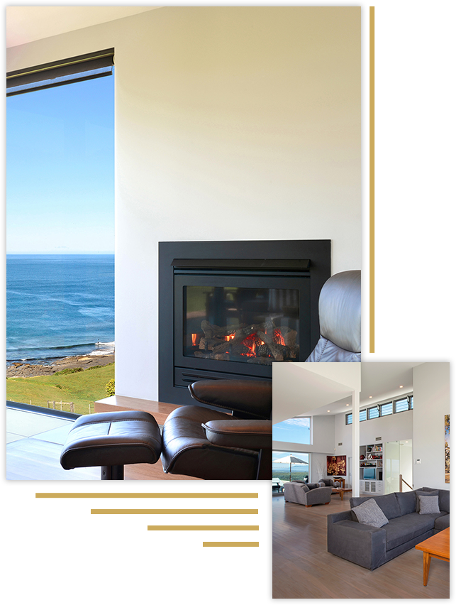 a sitting room with a gas log fireplace along with ocean views in the background