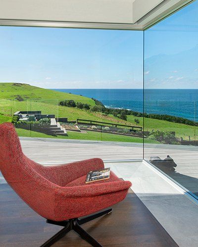 a room with beautiful views of the ocean and farmland