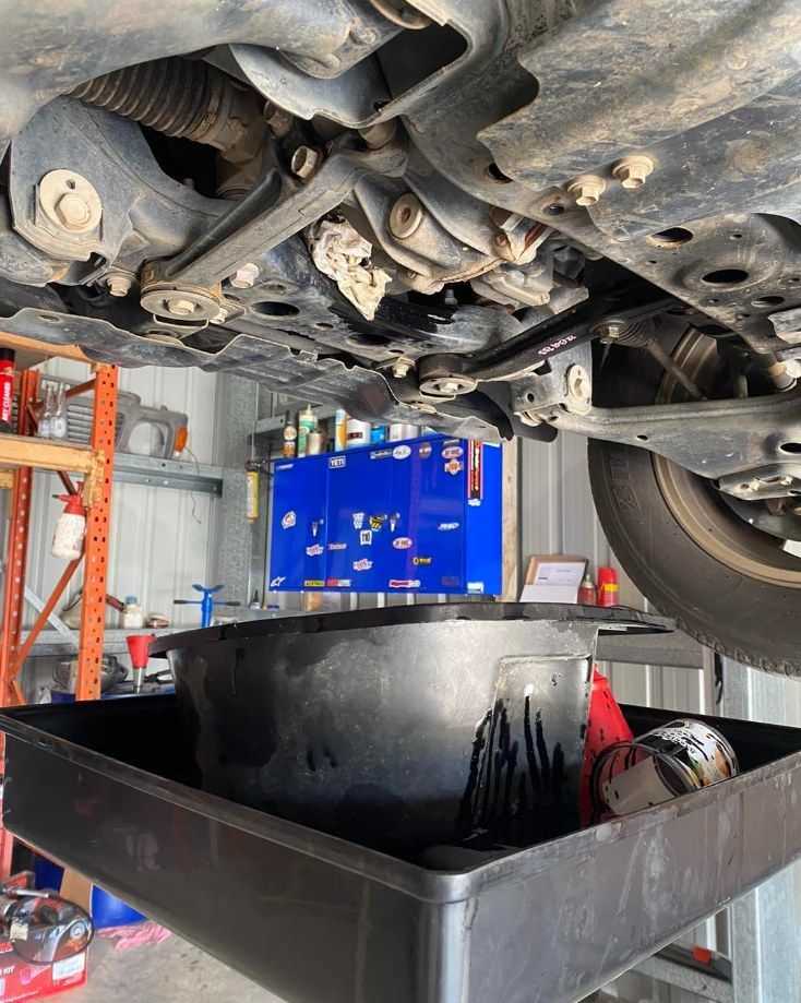 Car Undergoing Oil Change Upon Inspection — I & J Mechanical in Deeragun, QLD