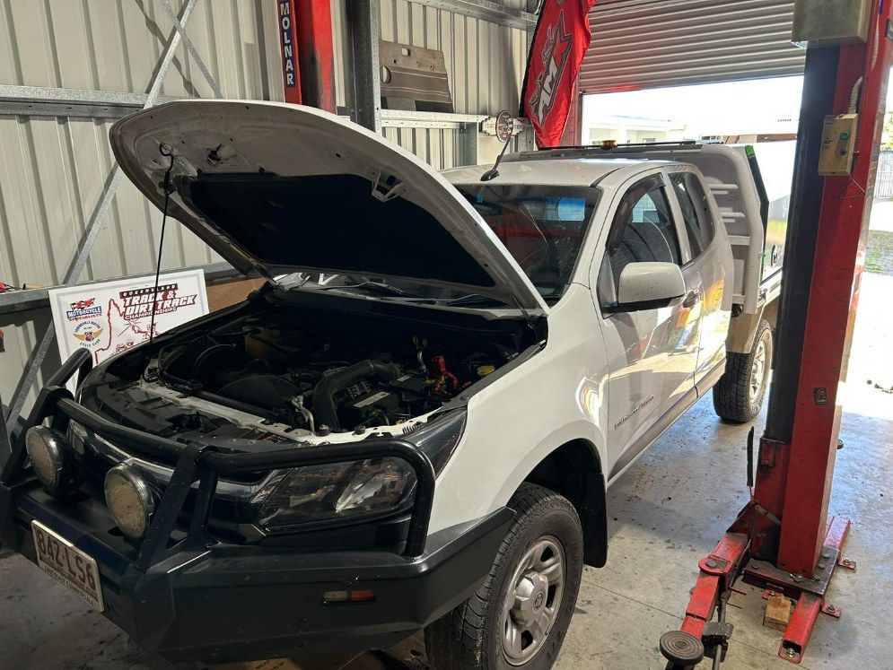 Pickup Truck With Open Hood in a Garage — I & J Mechanical in Deeragun, QLD