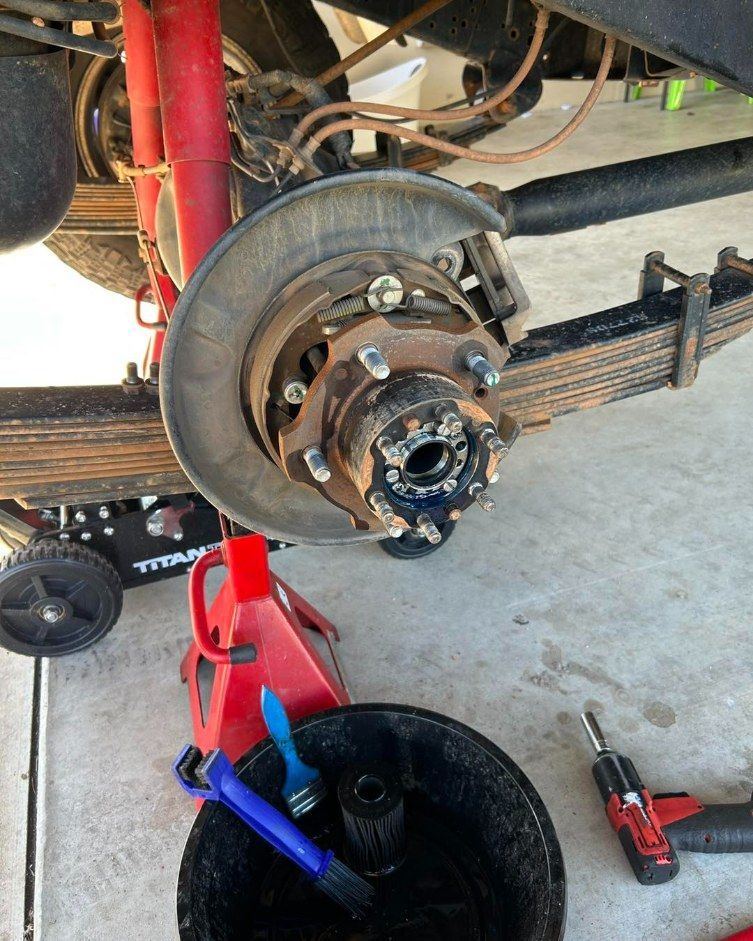 A Vehicle's Front Axle Being Worked on — I & J Mechanical in Deeragun, QLD