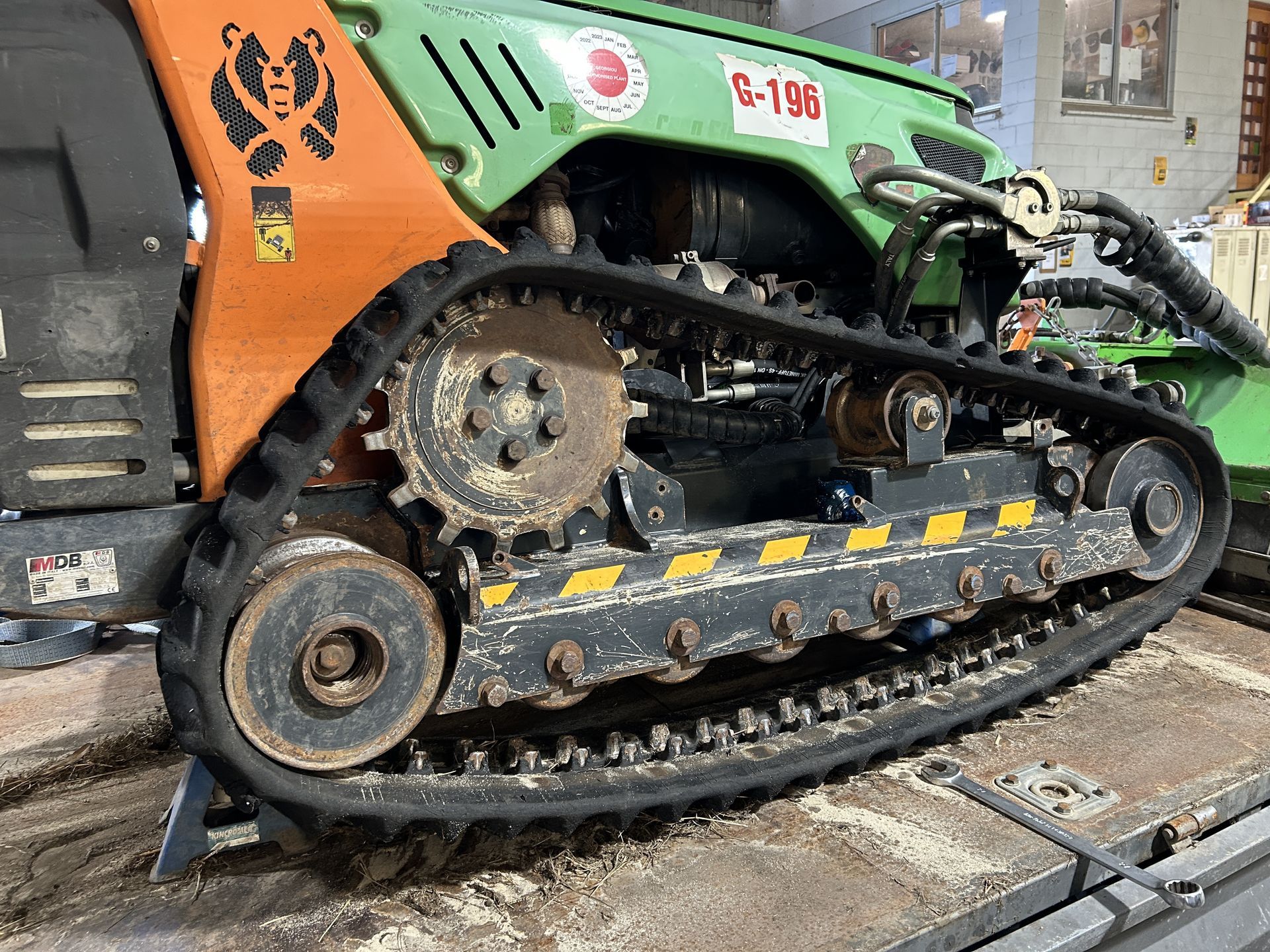 A Green Tractor With a Mower Cuts Grass — I & J Mechanical in Deeragun, QLD