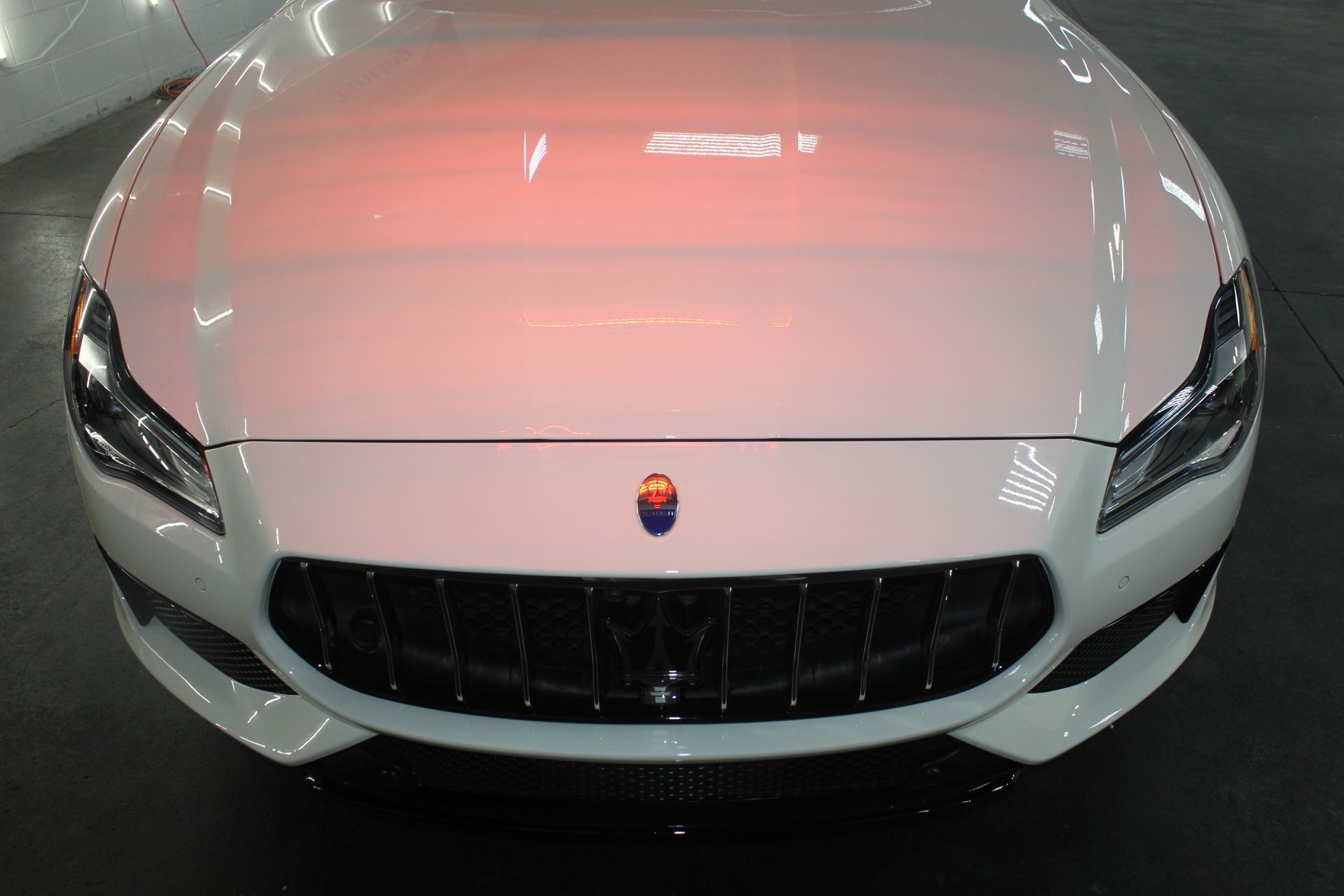 Front view of a white sports car with a black grille and headlights