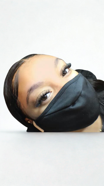 The woman is wearing a purple dress and a purple jacket.