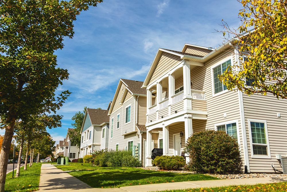 A row of houses sitting next to each other on a sunny day.