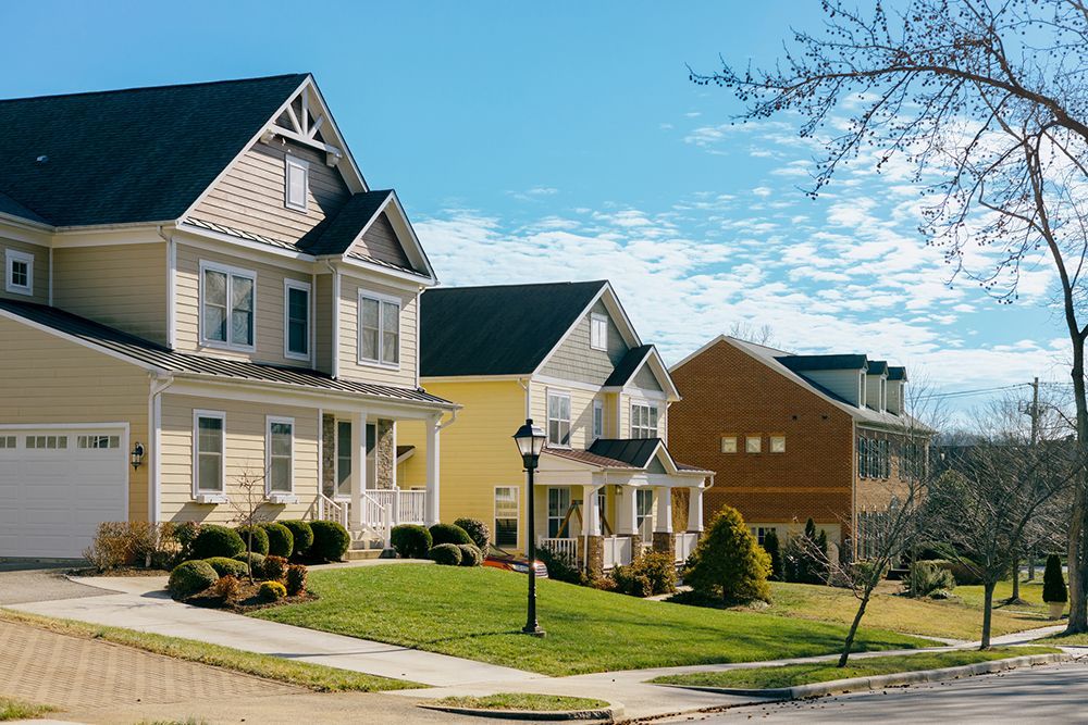 A row of houses in a residential neighborhood on a sunny day.